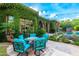 Charming patio area with colorful seating and an ivy-covered home exterior at 16469 N 113Th Way, Scottsdale, AZ 85255