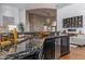 Entertain with ease at this bar featuring striking countertops, a stone archway, and ample wine storage at 16469 N 113Th Way, Scottsdale, AZ 85255