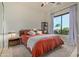 Bright bedroom featuring a large window with views, ceiling fan and carpeted floors at 16469 N 113Th Way, Scottsdale, AZ 85255