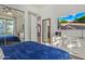 This bedroom boasts a television, sleek dresser, and inviting blue bedding at 16469 N 113Th Way, Scottsdale, AZ 85255
