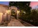 Charming entry to a private courtyard with stone pathway and wrought iron gate under an archway with sconces at 16469 N 113Th Way, Scottsdale, AZ 85255