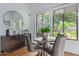 Bright breakfast nook features a round table, decorative mirror, and views of the beautiful desert landscape at 16469 N 113Th Way, Scottsdale, AZ 85255
