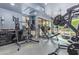 A well-equipped home gym with modern machines and sleek, dark cabinetry at 16469 N 113Th Way, Scottsdale, AZ 85255