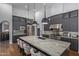This contemporary kitchen boasts a large center island, modern lighting, and stainless steel appliances at 16469 N 113Th Way, Scottsdale, AZ 85255