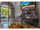 Living room features marble fireplace, glass doors with pool view, and modern decor at 16469 N 113Th Way, Scottsdale, AZ 85255