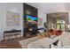 Open-concept living room with fireplace, stylish decor, and exposed stone archway at 16469 N 113Th Way, Scottsdale, AZ 85255