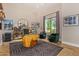 This bright office features a unique wooden desk and comfortable green seating at 16469 N 113Th Way, Scottsdale, AZ 85255