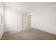 A minimal carpeted bedroom with a double door closet and a bright and airy atmosphere at 17250 W Via Dona Rd, Surprise, AZ 85387
