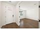 Bright entryway featuring wood flooring, a white front door, and an open doorway at 17250 W Via Dona Rd, Surprise, AZ 85387