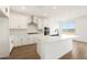 Well-lit kitchen featuring white cabinets, stainless steel appliances, and an island at 17250 W Via Dona Rd, Surprise, AZ 85387