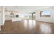 Bright and airy living room with wood floors, an open layout and sliding glass doors at 17250 W Via Dona Rd, Surprise, AZ 85387