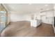 Open-concept space featuring wood floors, modern kitchen, and lots of natural light at 17250 W Via Dona Rd, Surprise, AZ 85387