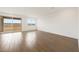 Large living room featuring sliding glass doors and wood-style flooring at 17250 W Via Dona Rd, Surprise, AZ 85387