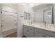 Bright bathroom features double sinks, a large mirror, and a shower-tub combination at 17319 W Via Dona Rd, Surprise, AZ 85387