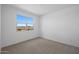 This carpeted bedroom offers a large window with beautiful views of the surrounding area at 17319 W Via Dona Rd, Surprise, AZ 85387