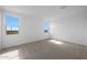 Comfortable bedroom with two windows providing natural light and scenic views at 17319 W Via Dona Rd, Surprise, AZ 85387