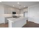 Stylish kitchen boasts white cabinets, modern appliances, and a functional center island at 17319 W Via Dona Rd, Surprise, AZ 85387
