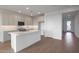 Bright kitchen featuring white cabinets, quartz countertops, and a large center island at 17319 W Via Dona Rd, Surprise, AZ 85387