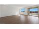 Open living room with wood-look tile floors and sliding glass doors to the patio at 17319 W Via Dona Rd, Surprise, AZ 85387