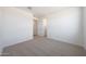 Neutral bedroom with plush carpeting, with open doorways and a closet for easy storage at 17429 W Via Dona Rd, Surprise, AZ 85387
