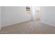 Bright bedroom featuring neutral carpeting and a walk-in closet for ample storage at 17429 W Via Dona Rd, Surprise, AZ 85387