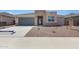Inviting single-Gathering home featuring a two-car garage and low-maintenance desert landscaping at 17429 W Via Dona Rd, Surprise, AZ 85387