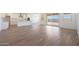 Open-concept living space featuring sleek tile floors, plenty of natural light, and access to the backyard at 17429 W Via Dona Rd, Surprise, AZ 85387