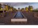 An impressive water feature and tiled planters that enhance the beauty of the surrounding landscape at 17560 W Crawfordsville Dr, Surprise, AZ 85388
