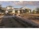 Exterior view of the community clubhouse with an inviting facade, hardscape, and manicured landscaping at 17560 W Crawfordsville Dr, Surprise, AZ 85388