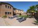 Manicured backyard with a seating area, lounge chairs, green grass and a view of the home at 17981 W Agave Rd, Goodyear, AZ 85338