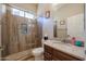 Bathroom with tiled shower, single vanity, framed mirror, and a toilet at 17981 W Agave Rd, Goodyear, AZ 85338