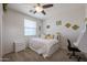 Bright bedroom with carpet featuring a dedicated workspace and natural lighting at 17981 W Agave Rd, Goodyear, AZ 85338