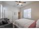 Bedroom featuring soft carpet, a ceiling fan, sofa, and closet at 17981 W Agave Rd, Goodyear, AZ 85338