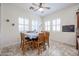 Bright dining room features large windows, a ceiling fan, and a table with seating for six at 17981 W Agave Rd, Goodyear, AZ 85338