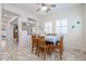 Bright dining room featuring wood table and seating for six with plantation shutters at 17981 W Agave Rd, Goodyear, AZ 85338