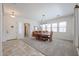 Bright dining room with a large wood table, carpet flooring, and plenty of natural light at 17981 W Agave Rd, Goodyear, AZ 85338