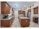 Modern kitchen with stainless steel appliances, granite countertops, and ample cabinet space at 17981 W Agave Rd, Goodyear, AZ 85338
