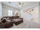 Living room with a large sectional sofa and a view to a stairway at 17981 W Agave Rd, Goodyear, AZ 85338