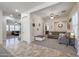 Open-concept living room with neutral paint, tile entry, and comfortable furnishings at 17981 W Agave Rd, Goodyear, AZ 85338