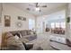 Living room with brown sectional sofa, and a view into the dining area at 17981 W Agave Rd, Goodyear, AZ 85338