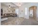 Inviting living room featuring carpet, a sectional sofa, and an arched doorway at 17981 W Agave Rd, Goodyear, AZ 85338