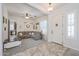 Comfortable living room with neutral tones, ceiling fan, and ample natural light at 17981 W Agave Rd, Goodyear, AZ 85338