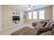 Comfortable loft featuring a carpeted floor and ceiling fan, along with a large sofa and wall-mounted TV at 17981 W Agave Rd, Goodyear, AZ 85338
