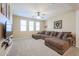 Comfortable loft space featuring a large sectional sofa, carpet, and a ceiling fan at 17981 W Agave Rd, Goodyear, AZ 85338