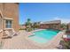 Private backyard oasis featuring a pool, seating area, and mature landscaping at 17981 W Agave Rd, Goodyear, AZ 85338
