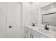 Bathroom featuring double sinks with dark hardware, and a door to another room at 18256 W La Senda Dr, Surprise, AZ 85387