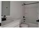 Bathroom featuring a white vanity, framed mirror, toilet and a bathtub with shower at 18256 W La Senda Dr, Surprise, AZ 85387