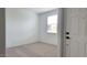 Bright bedroom featuring neutral carpet, white walls, and a window that allows natural light at 18256 W La Senda Dr, Surprise, AZ 85387