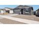 Attractive single-Gathering home features a gray exterior, two-car garage, and gravel landscaping for a low-maintenance yard at 18256 W La Senda Dr, Surprise, AZ 85387