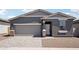 Attractive single-Gathering house boasts a two-car garage and stone veneer accents for added curb appeal at 18256 W La Senda Dr, Surprise, AZ 85387